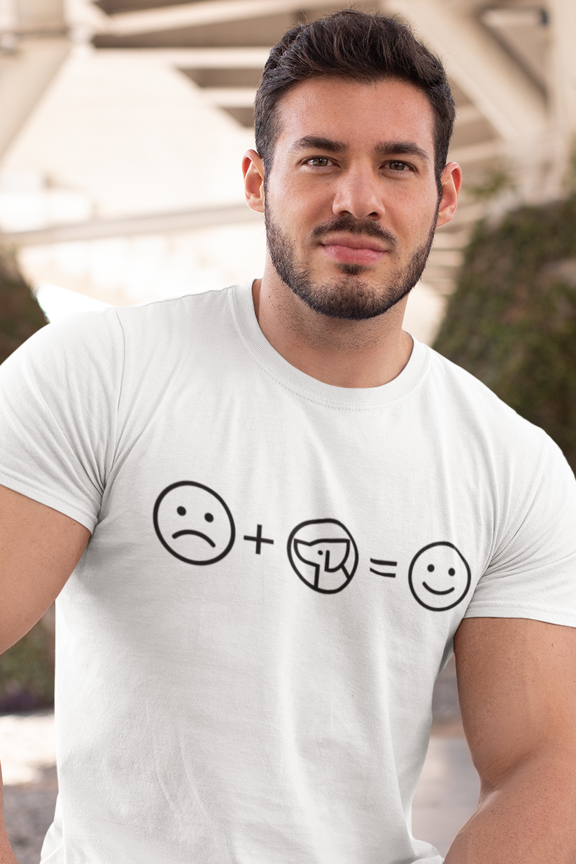 Man wearing a white t-shirt with a smiley face equation sitting outdoors.